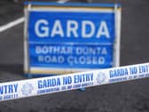 Garda tape next to a road closure sign