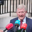 Head and shoulders photo of Sean Canney speaking into microphones outside a building