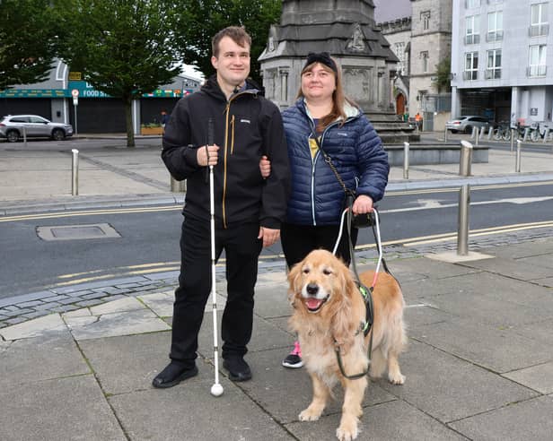 Ukrainian refugees Pavlo Romaniuk, 31, and Yuliia Nahaiets, 30, with their faithful guide dog Amigo. They are desperately hoping to remain in Limerick, but face an uphill battle | PICTURES: Adrian Butler