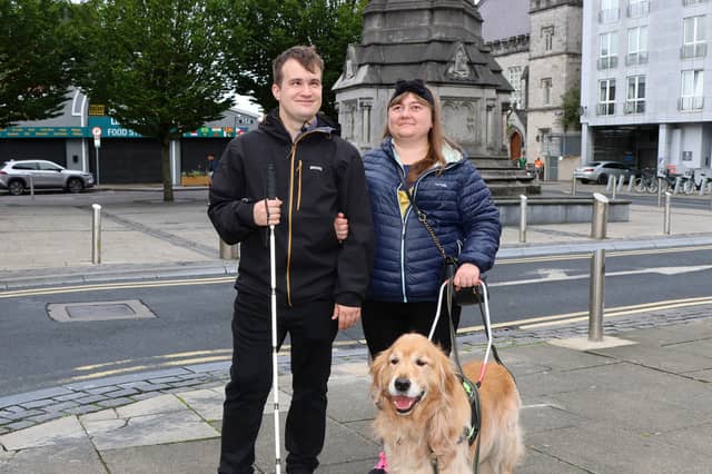 Ukrainian refugees Pavlo Romaniuk, 31, and Yuliia Nahaiets, 30, with their faithful guide dog Amigo. They are desperately hoping to remain in Limerick, but face an uphill battle | PICTURES: Adrian Butler