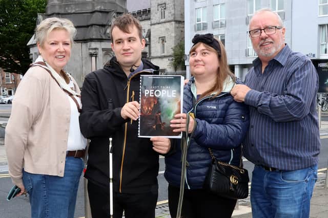 Pavlo and Yuliia with Geraldine Clancy and Paul Moriarty, Limerick Volunteer Centre with a copy of their book which sheds light on the experience of refugees with disabilities
