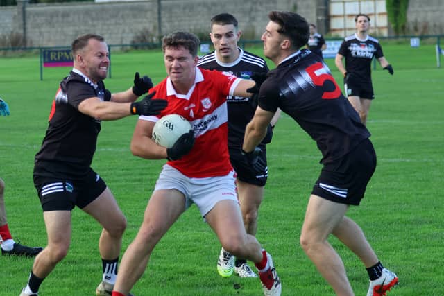 Monaleen's Andrew Kearney under pressure from Newcastle West pair Thomas Quilligan and Con Hayes during their Limerick SFC tie in Rathkeale