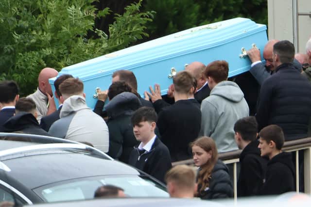 The remains of Bryan Lowe leaving the church