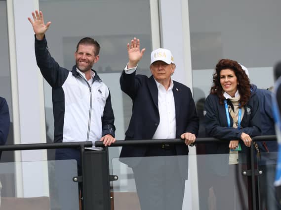 US President Donald Trump with his son Eric Trump waving to spectators
