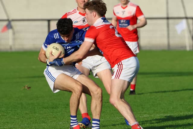 Andrew Meade, Rathkeale, under pressure from Jason Hassett, Mungret-St Paul's