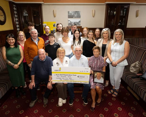 The family and friends of former Bohemian RFC captain John O’Grady presenting a cheque for €10,205 to Colin and Eithne Bell of the Kevin Bell Repatriation Trust 