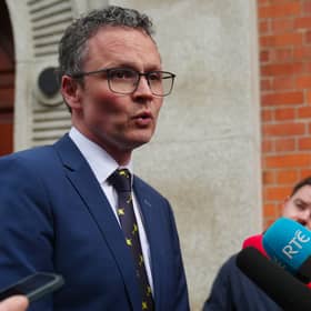 Minister Patrick O’Donovan addressing a media scrum