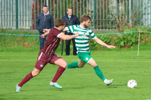 Pike Rovers player Dylan Murphy holding possession against Dean McNamara, Summerville Rovers in their Munster Junior Cup tie at Portland Park