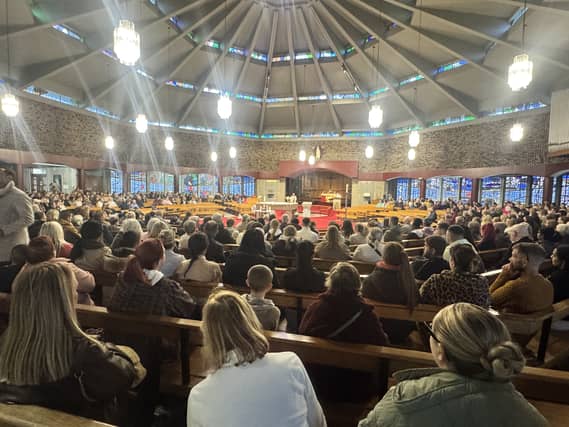 People during a vigil at Sacred Heart Church in Waterford