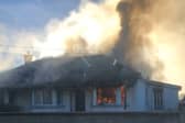 Thick plumes of black smoke from the house on fire in Manister, Croom