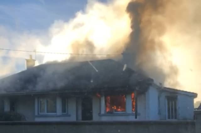 Thick plumes of black smoke from the house on fire in Manister, Croom