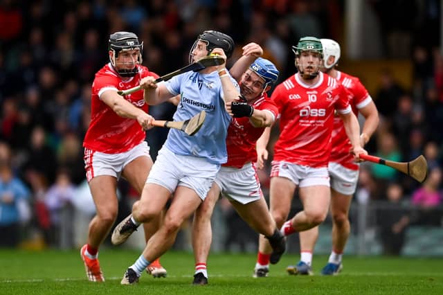 Peter Casey of Na Piarsaigh is tackled by Barry Murphy, left, and Aidan O'Connell of Doon during the county semi-final