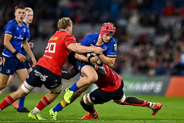 Gavin Coombes, left, and Edwin Edogbo of Munster tackle Leinster's Josh van der Flier in last season's game at the Aviva Stadium