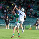 Will Henn, Na Piarsaigh and Mark O'Loughlin, Kilmallock, battle for the ball