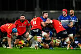 Munster's Gavin Coombes and Fineen Wycherley tackle Leinster's Joe McCarthy during their game at the Aviva Stadium