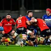 Munster's Gavin Coombes and Fineen Wycherley tackle Leinster's Joe McCarthy during their game at the Aviva Stadium