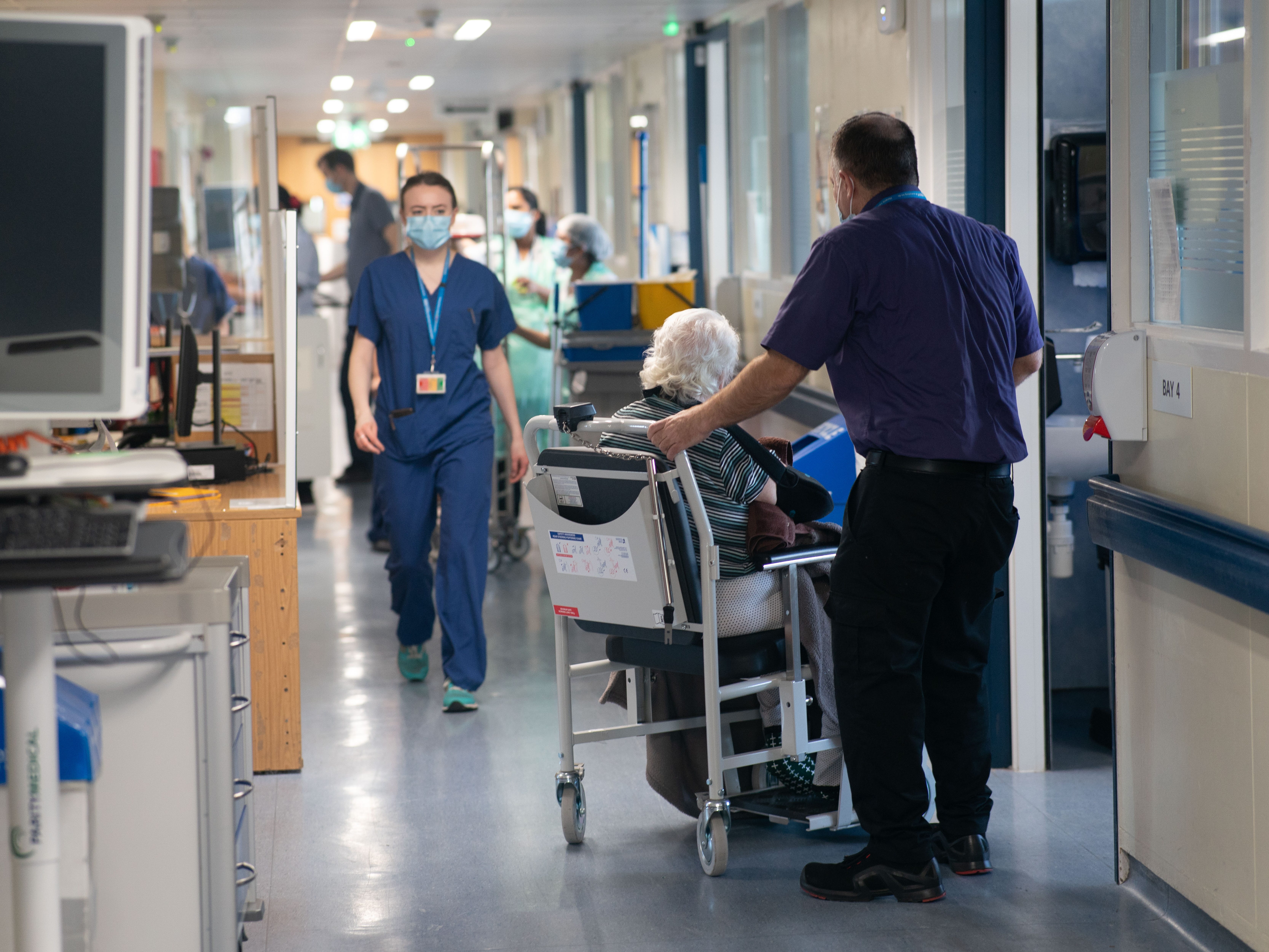 View of hospital staff and patients on a ward