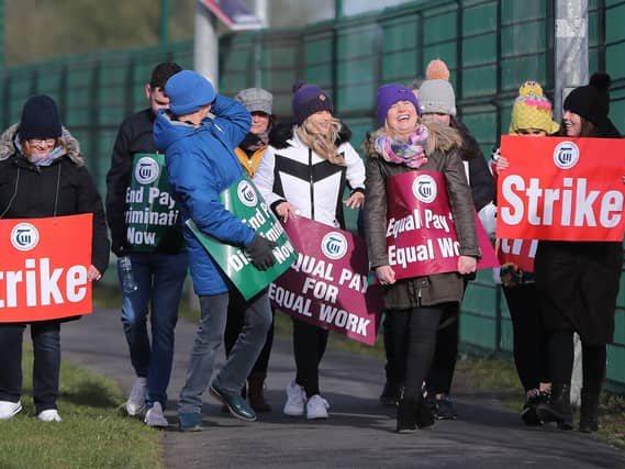 Striking teachers carrying placards