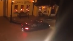Car left stranded after road floods outside one of Ireland's most well-known bars
