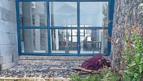 Homeless person sleeping rough outside Limerick City Hall 