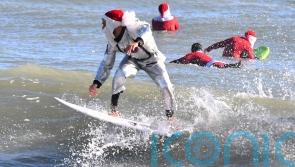 Frigid weather fails to stop Florida’s surfing Santas