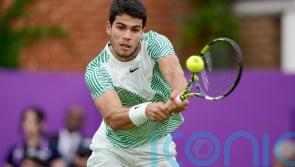 Carlos Alcaraz hopes to thrive on grass this summer after advancing at Queen’s