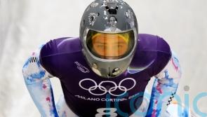 IOC urges Ukrainian racer to compete amid row over banned war victim helmet