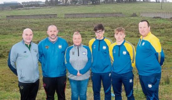 FAI development officer Jason O'Connor, coach Kieran Byrne, chairperson Karen O'Callaghan, youth players Reece Moran and Jeffery Dore, with coach James McCarthy at the wasteland