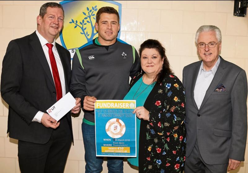 Munster star CJ Stander, flanked by Liam Brown and and Kieran MacSweeney, LIT, making a donation to Linda Ledger, manager of the St Munchin's community centre Pictures: Adrian Butler