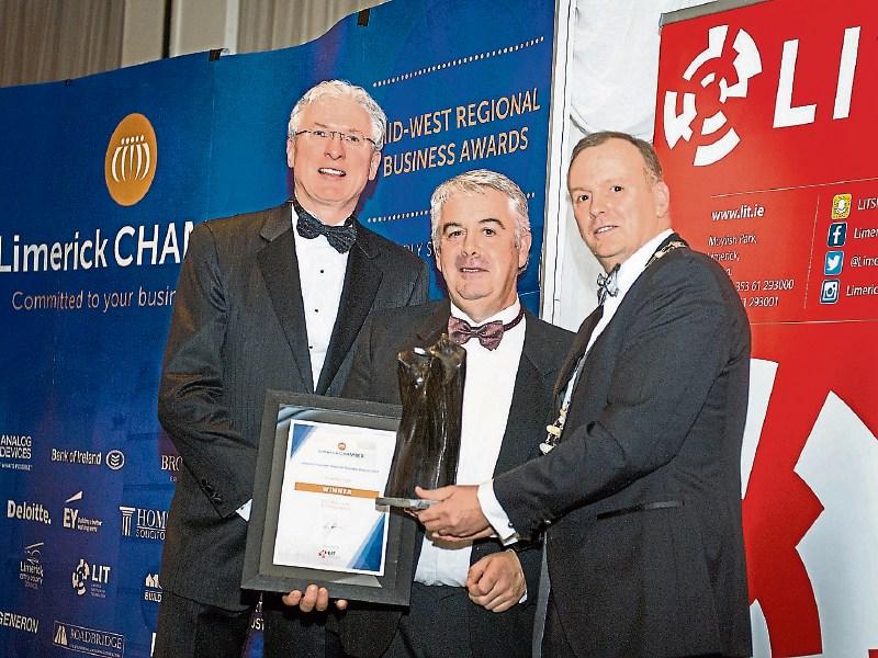 Pictured at last year’s Chamber business awards, Conor Gilligan of the overall winners Roadbridge, flanked by Donal Creaton, Holmes O’Malley Sexton, award sponsor, and former Chamber president Ken Joh