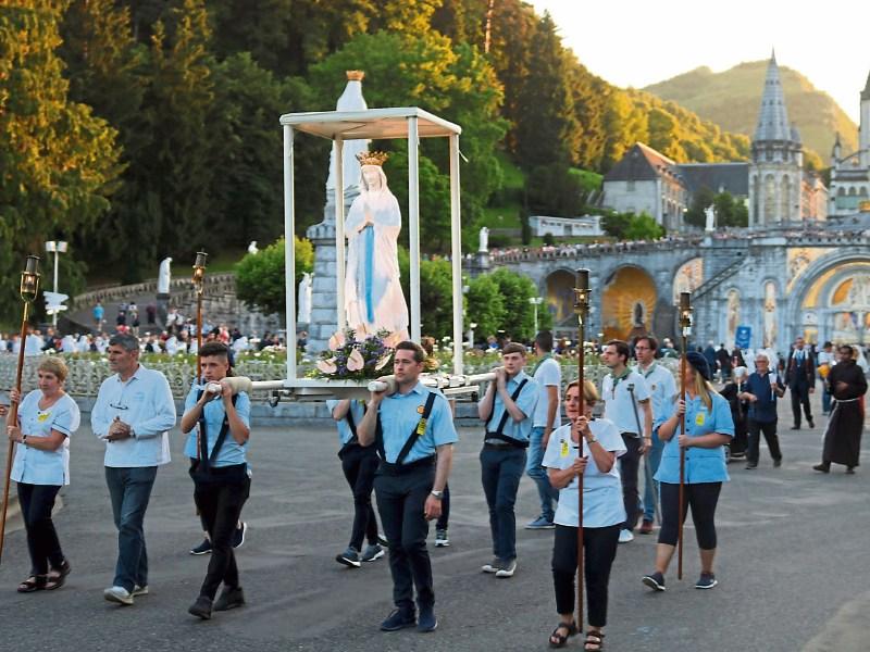 The Limerick brancardier carry the statue of the Blessed Virgin in the torchlight procession Pictures: Michael Cowhey