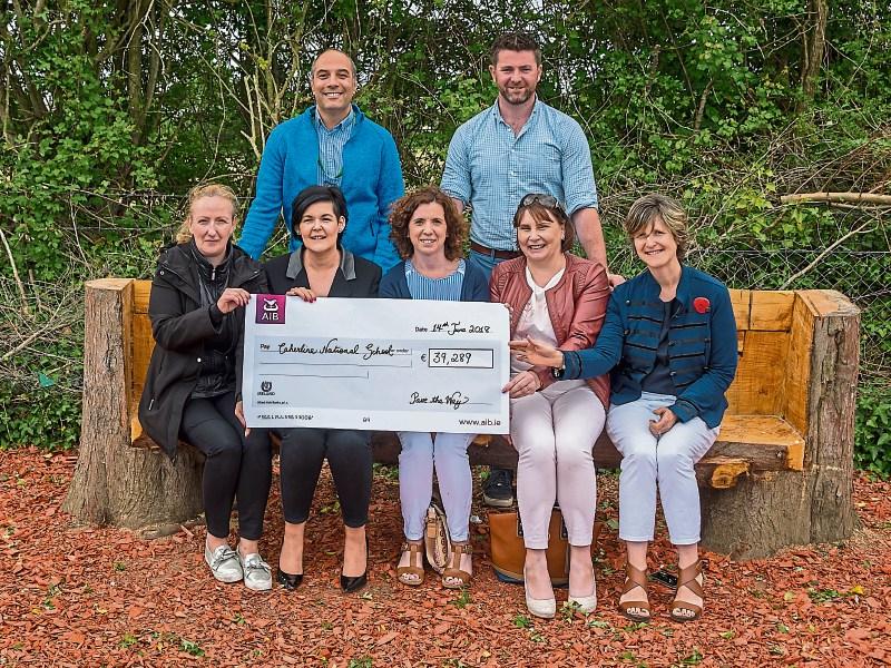 Smiling Caherline NS parents association and principals with the cheque