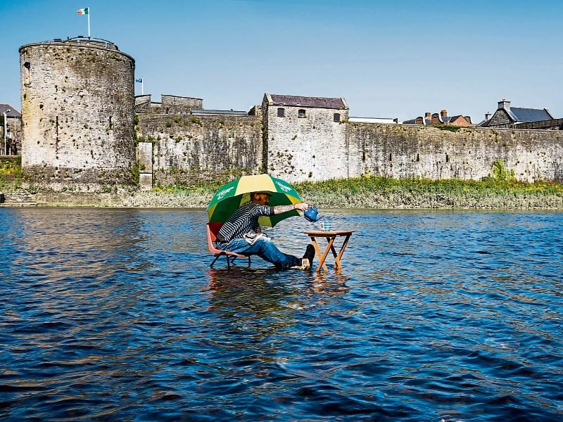 Paul “Daigo” O'Driscoll cooling off with a cup of tea on the Shannon n front of King John’s Castle Picture: Kieran Ryan-Benson