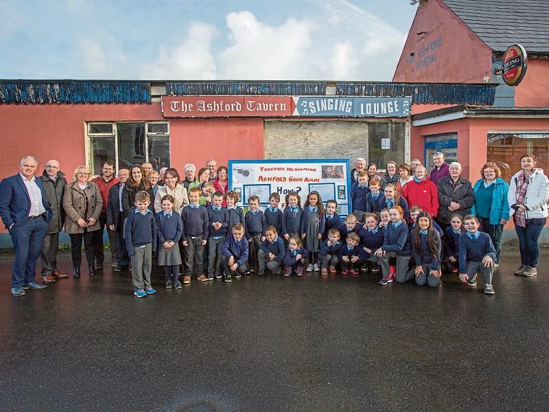 The Ashford Community Resource Centre committee and local school children were pictured outside the old Ashford Tavern, which will be developed into a community resource centre