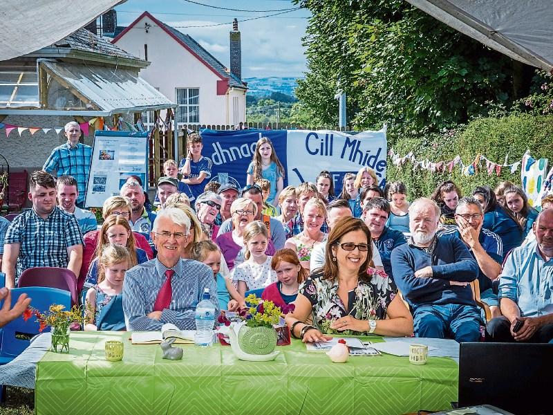 Pride of Place judges Tom and Alison Dowling, seated at table, with locals in Kilmeedy during Monday’s judging Picture: Keith Wiseman