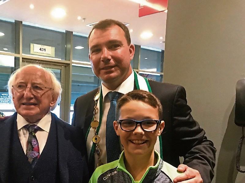 Mayor James Collins with his son Daniel, 11, meeting President Michael D Higgins post-game