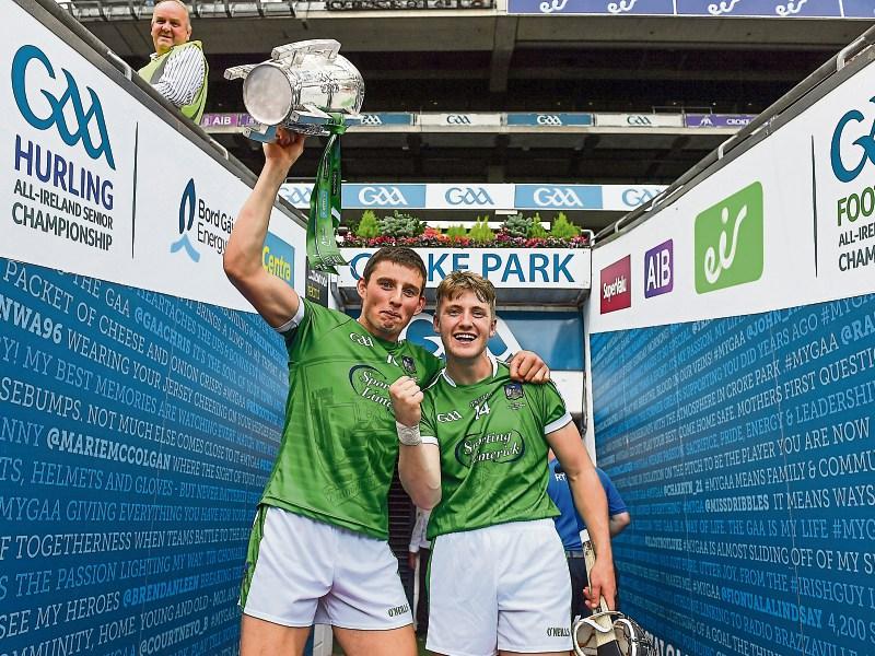 Gear&oacute;id Hegarty, left, and S&eacute;amus Flanagan of Limerick leave the pitch with the Liam MacCarthy Cup