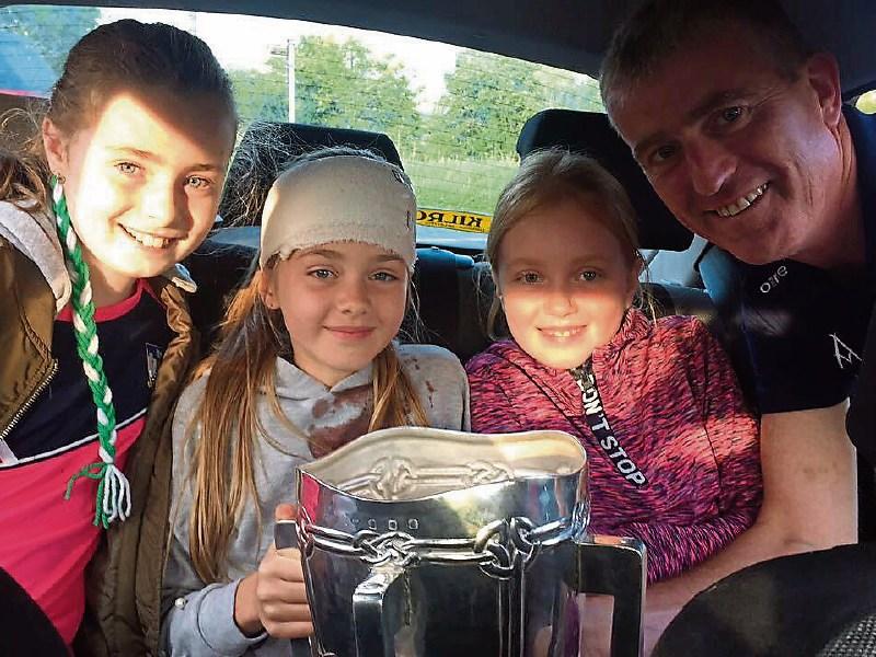 Chloe Rogers, second left, pictured with the Liam MacCarthy Cup after she got  an accidental belt of a hurley during the homecoming