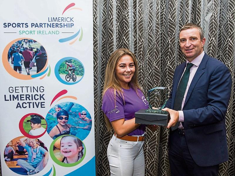 Chelsea Harty from Salesian Secondary College, Pallaskenry, receives her award from Niall Collins TD
