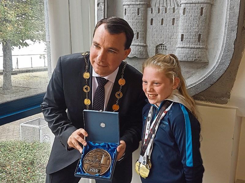 Mayor of Limerick City and County Council, James Collins presents Tara Madigan, Castleconnell, with a plaque at a special reception