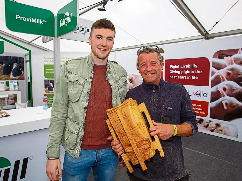 Declan Hannon with chainsaw sculptor Will Fogarty and his specially carved replica of the Liam McCarthy Cup at the Ploughing Championships