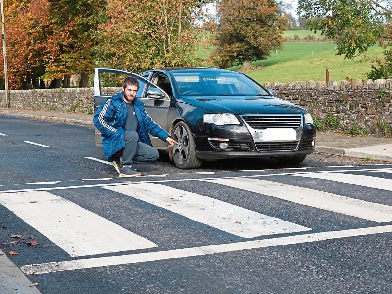 Christopher Fitzgibbon with his Passat at the pedestrian crossing in Galbally, which he says his car can&rsquo;t travel over Picture: Michael Cowhey