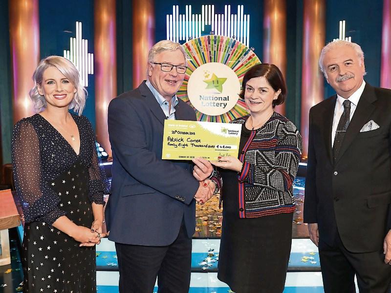 Patrick Comer receives his cheque from Mari Hurley with Sinead Kennedy and Marty Whelan Picture: Mac Innes Photography
