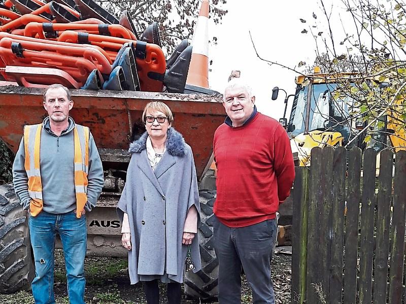 John Morrissey contractor, Cllr Elenora Hogan, and Donal Fitzgibbon discussing details about the proposed water main replacement