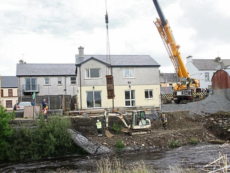 Workers erecting thirty sheets of steel to protect the Roches family home in Abbeyfeale