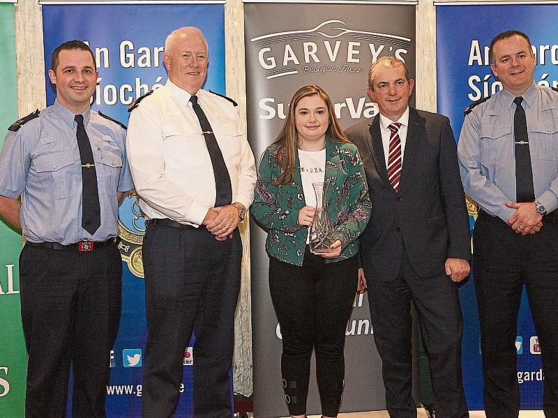 Chief Superintendent Gerard Roche presents a Garda Youth Award to Jade Purcell from  Rosbrien with Garda Paul Howard Kevin McCarthy, Garvey group and Insp Ollie Kennedy