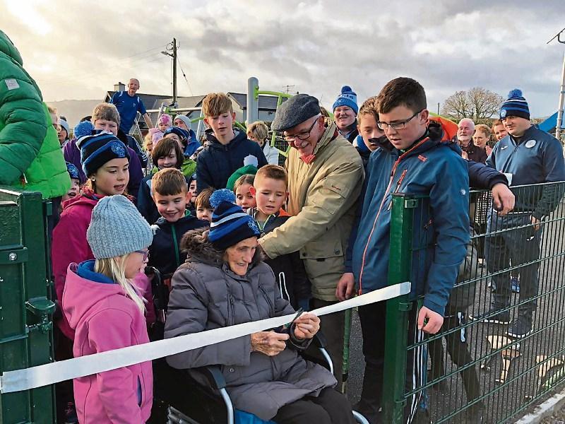 Kathleen Moloney, Killeedy’s most senior citizen, cuts the ribbon on the children’s playground in Raheenagh