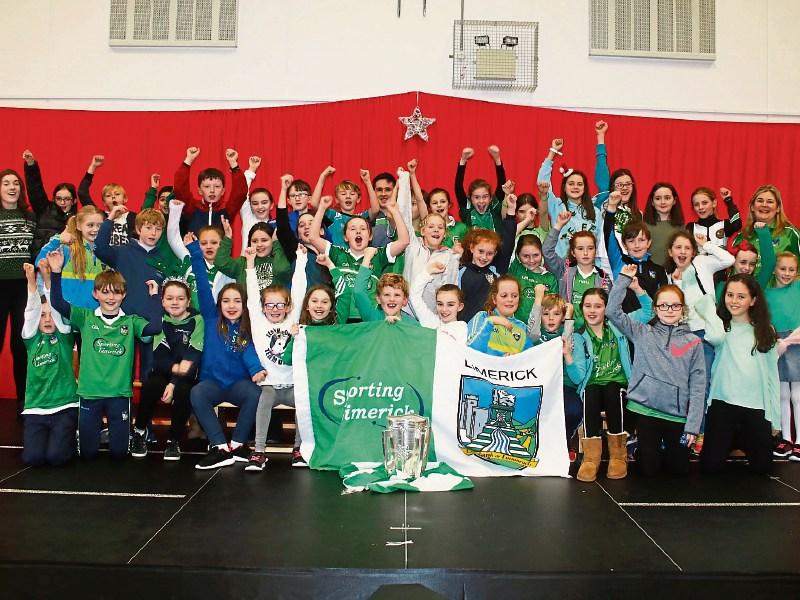 Some of the young pupils of Gaelscoil an R&aacute;ith&iacute;n who along with staff welcomed hurler Darragh O'Donovan and the Liam MacCarthy Cup