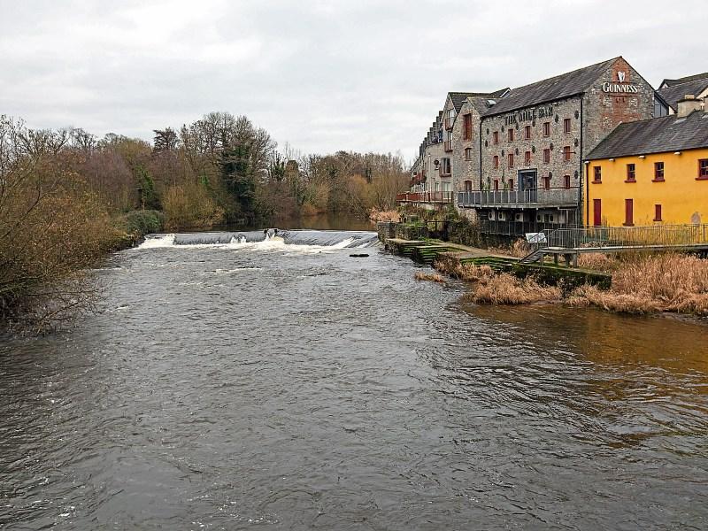 The Mulcair River flowing through Annacotty, where hooded members of a gang can be seen attempting to smash the windows of a local business, below