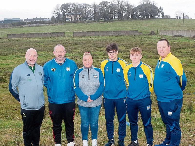 FAI development officer Jason O'Connor, coach Kieran Byrne, chairperson Karen O'Callaghan, youth players Reece Moran and Jeffery Dore, with coach James McCarthy at the wasteland